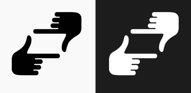 Hand Framing Icon on Black and White Vector Backgrounds Hand Framing Icon on Black and White Vector Backgrounds. This vector illustration includes two variations of the icon one in black on a light background on the left and another version in white on a dark background positioned on the right. The vector icon is simple yet elegant and can be used in a variety of ways including website or mobile application icon. This royalty free image is 100% vector based and all design elements can be scaled to any size. finger frame stock illustrations