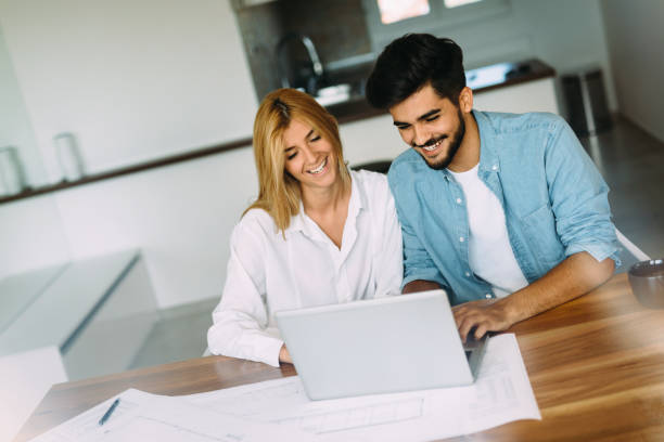 istock Handsome young man and attractive woman working on laptop 802480338