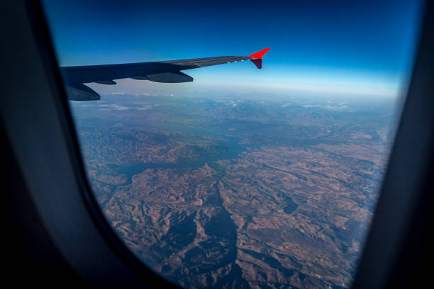 istock Wing of an airplane flying above the clouds 802480654
