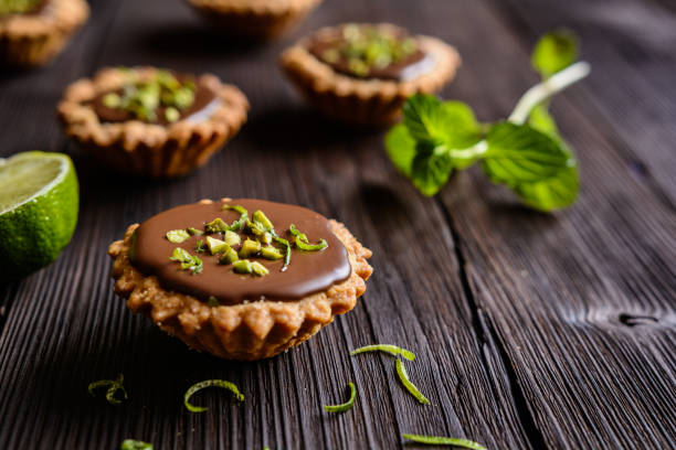 istock Tartlets with chocolate, pistachios and lime peel 802492488