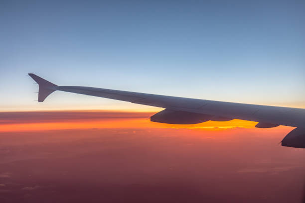 istock Wing of an airplane flying above the clouds 802492946