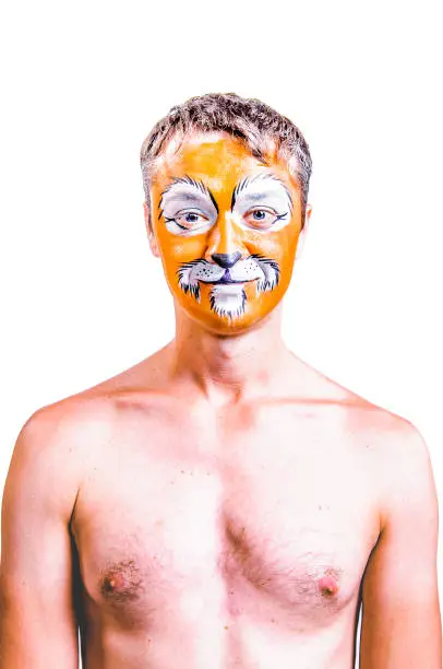 Close-up portrait of smiling and fooling around animator in lion theater role. No suit, topless. Emotional and colorful portrait. Isolated background