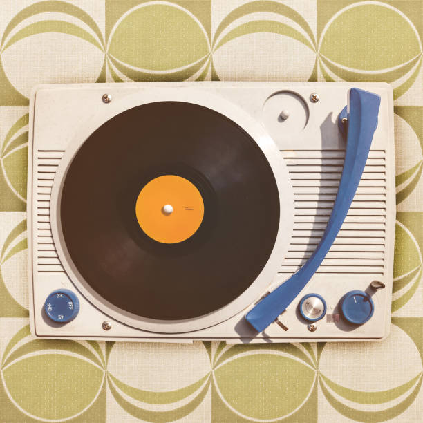 istock Vintage vinyl turntable player on retro wallpaper 802496522