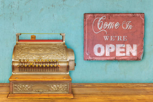 Store concept with cash register and sign come in we are open