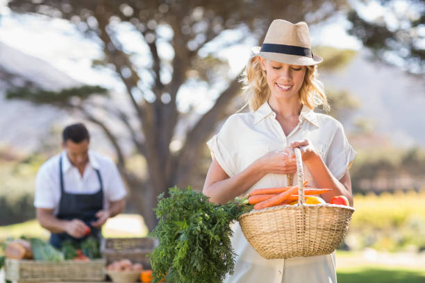 istock Blonde woman holding a vegetables basket 802501260