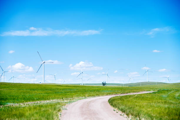 istock Dirt road and wind turbine on the grassland 802517608