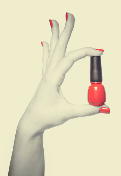 istock Nail polish in hand, close-up, toned 802524650
