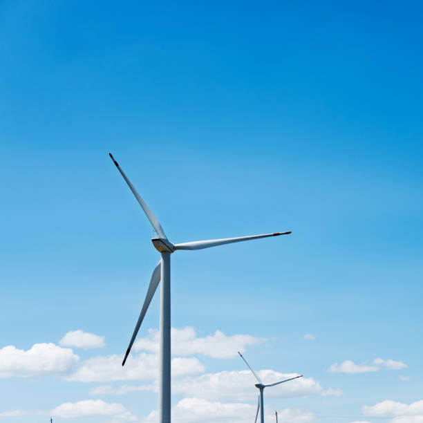 istock Wind turbine in blue sky 802531288