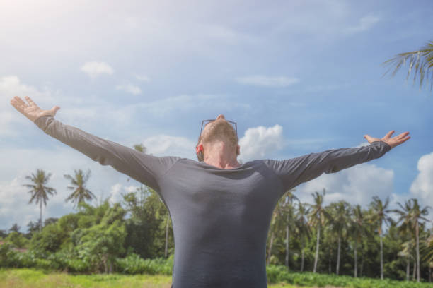 istock Man with arms wide open enjoying in nature. 802540014