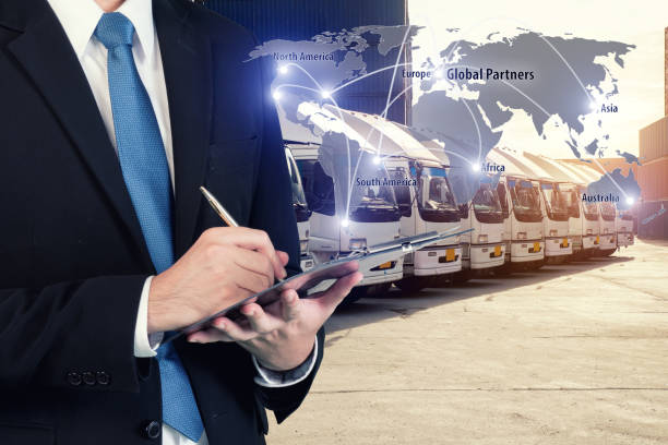 istock Businessman is booking with blurred cargo , transportation port and world map. Transportation logistic business concept. Elements of this image furnished by NASA 802542704