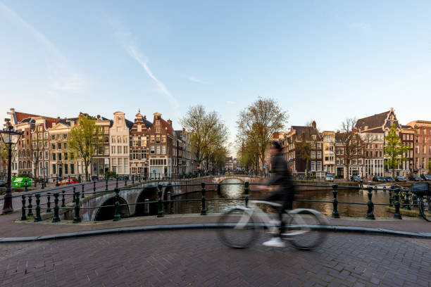 istock Amsterdam people riding bicycles in historical part in Amsterdam, Netherlands. 802543092