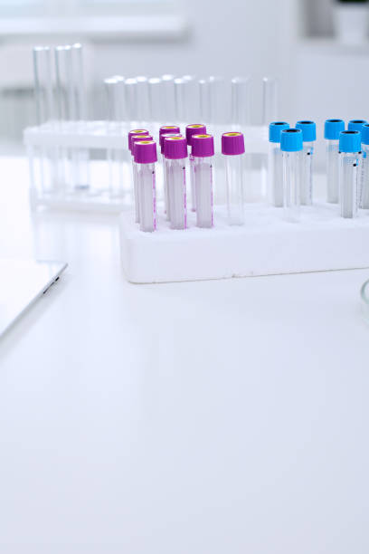 istock Research laboratory working space. Test tubes and tablet PC are lying at the table. 802544042
