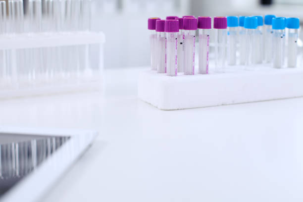 istock Research laboratory working space. Test tubes and tablet PC are lying at the table. 802544270
