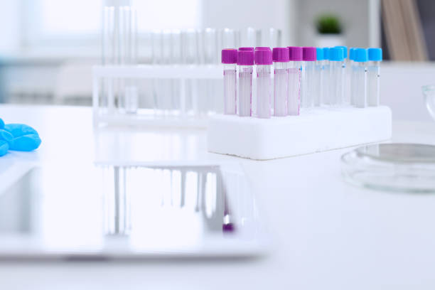 istock Research laboratory working space. Test tubes and tablet PC are lying at the table. 802544332