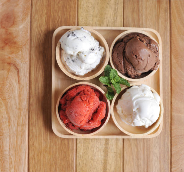 istock Homemade mixed  Ice cream scoops on wooden bowl 802545886