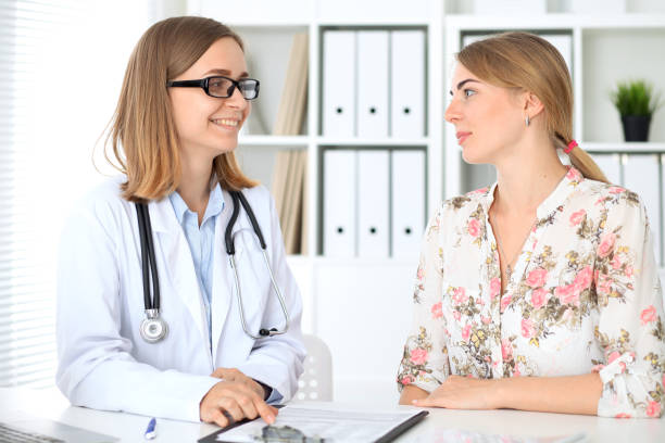 istock Doctor and  patient  sitting at the desk 802546256