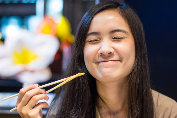 istock Asian woman eating with chopsticks 802546560