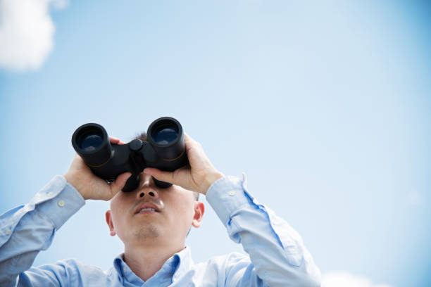 istock A man looks at the sky with a binoculars 802546624
