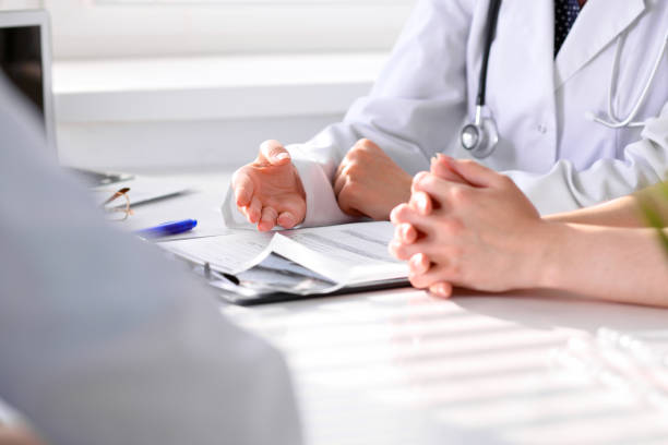 istock Doctor and patient are discussing something, just hands at the table 802551488