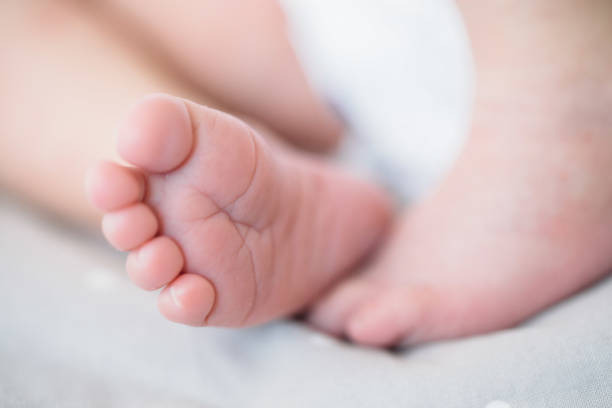 istock newborn Feet. Children concept 802551652