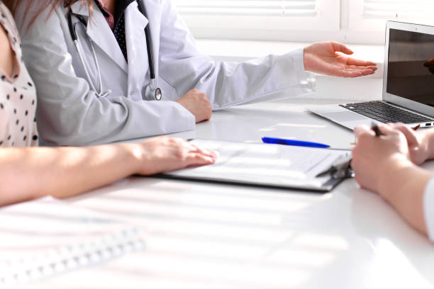 istock Doctor and patient are discussing something, just hands at the table 802552002