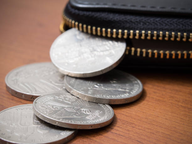 istock Coins and wallet on a wooden table 802558374