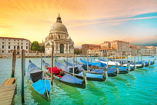 Incredible optimistic color landscape of gondolas on the Grand Canal in the background Basilica Santa Maria della Salutein at dawn in Venice, Italy, Europe. (Romantic travel, honeymoon - concept)