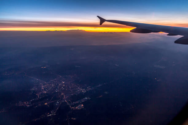 istock Wing of an airplane flying above the clouds 802566158