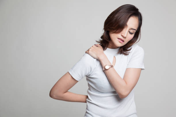 istock Young Asian woman got back pain. 802566326