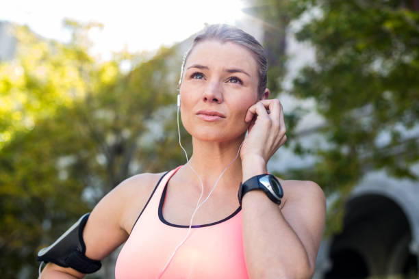istock A beautiful athlete putting her headphones 802573778