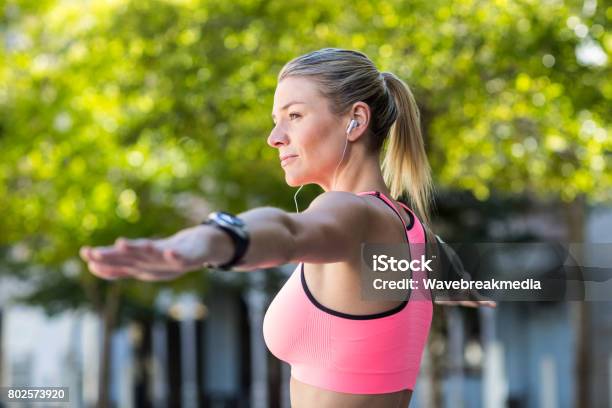 A Beautiful Athlete Stretching Her Arms Stock Photo - Download Image Now - 20-29 Years, 25-29 Years, Active Lifestyle