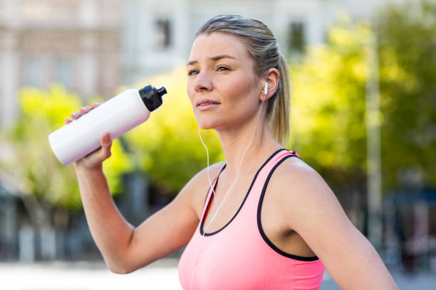 istock A beautiful woman drinking water 802578390