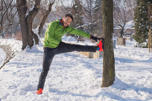 istock Handsome young runner on the snow.Colored photo 802578512