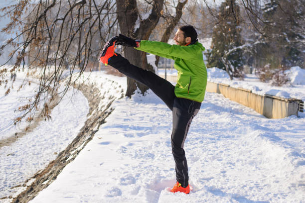 istock Handsome young runner on the snow.Colored photo 802581572