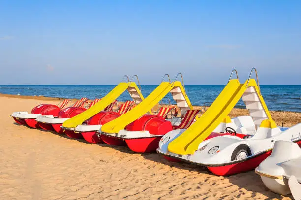 Colorful series of pedalo parked on the beach