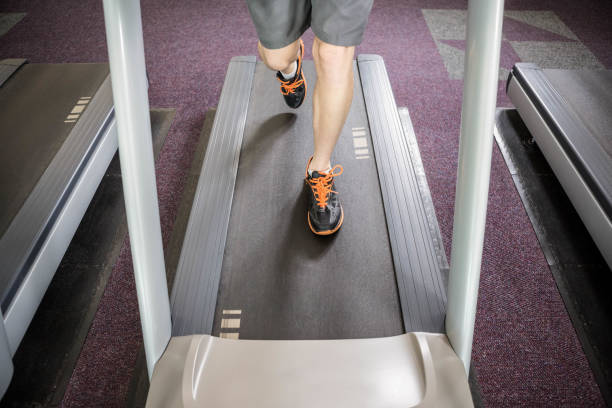 istock Lower section of man running on treadmill 802582130