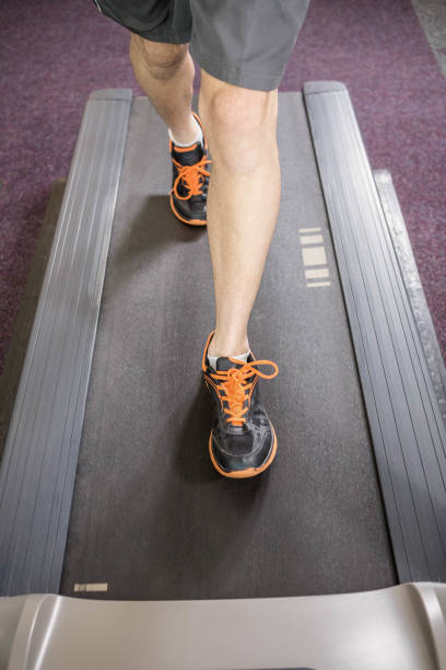 istock Lower section of man running on treadmill 802582148