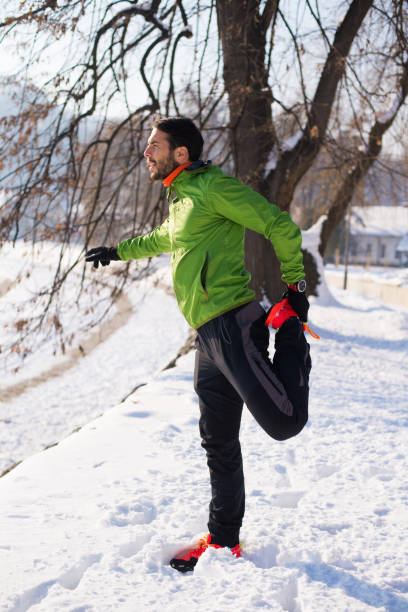 istock Handsome young runner on the snow.Colored photo 802582244