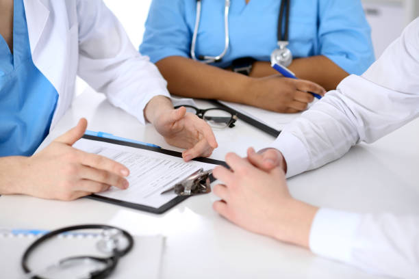 istock Two doctors and male patient discussing medical history 802582714