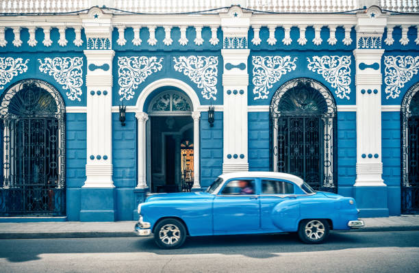 Old vintage car in front of colonial style house, Cuba Old vintage car on the street, Camagüey Cuba historic district photos stock pictures, royalty-free photos & images