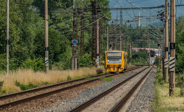 istock Yellow and orange train near Kostov station 802589530