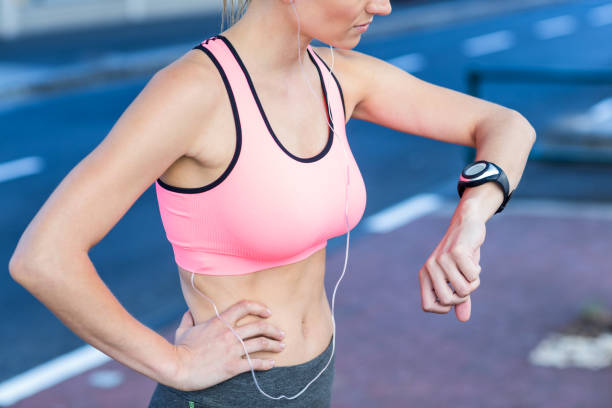 istock A beautiful athlete watching her watch 802595648