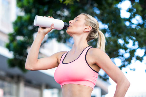 istock A beautiful woman drinking water 802595754