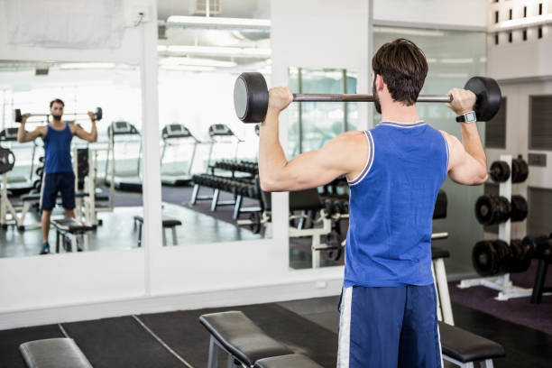 istock Muscular man lifting barbell 802602114