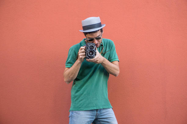 istock Young man photographing with an old camera 802602432