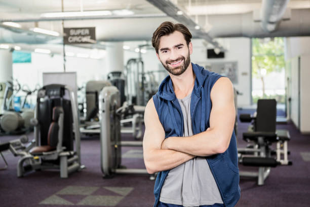 istock Handsome man standing with arms crossed 802602502
