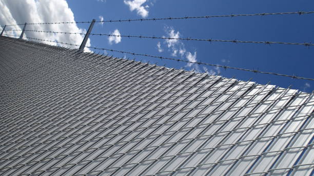 istock Chain link fence, looking at sky 802605580