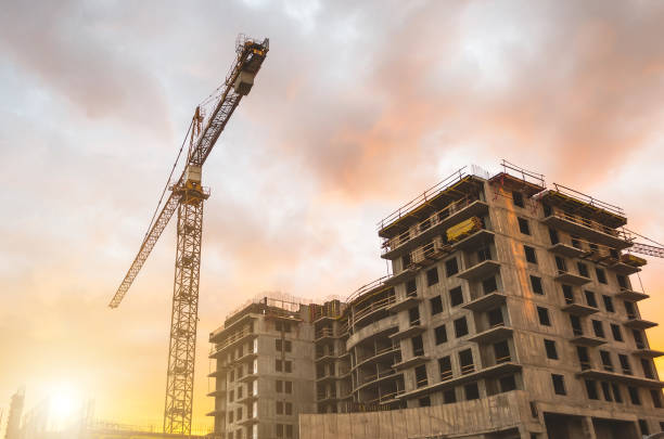 istock Building crane at sunset and building an orange sky. 802605584