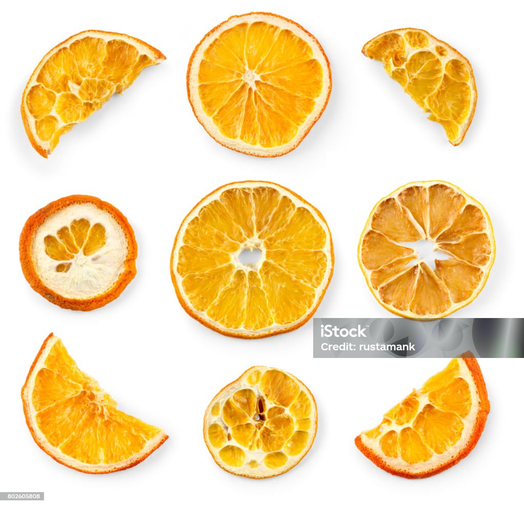 Set of dried slices and half a slice of orange and lemon, isolated on white background Dried Food Stock Photo