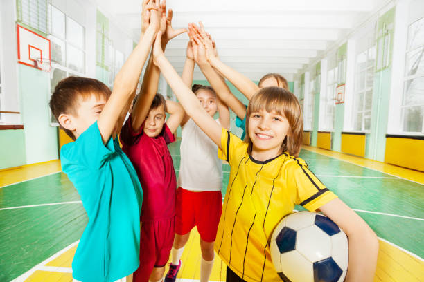 istock Happy football winners giving high five together 802618364